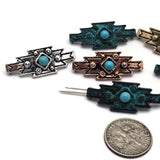Mixed finish western slider beads featuring bright faux turquoise center stones and tribal-inspired geometric designs. Decorative metal accents and textured surfaces create a rustic artisan appearance. Displayed with a dime and beading pins for scale and construction reference, these 2 Hole Slider Beads are excellent for handmade jewelry, statement bracelets, necklaces, leather accessories, and Southwestern-inspired jewelry making supplies.