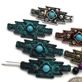Western geometric slider beads with faux turquoise center stones and decorative raised floral accents throughout the metalwork. The assortment includes several antique finishes that coordinate beautifully with leather, turquoise beads, and rustic jewelry components. Displayed with size references, these 2 Hole Slider Beads are perfect for handcrafted bracelets, statement necklaces, artisan beadwork, Southwestern accessories, and one-of-a-kind jewelry creations.