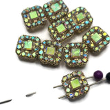 The shimmering Aurora Borealis finish on these Clear AB Rhinestone Slider Beads creates flashes of color that change beautifully in different lighting conditions. Set in a bright gold finish, these focal beads work wonderfully in bracelets, necklaces, pendants, earrings, and bead weaving projects. Their dual-hole design provides stability and alignment, making them excellent additions to multi-strand jewelry and other handmade jewelry creations.