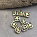 Bring brilliant sparkle to your jewelry collection with these Clear AB 2 Hole Slider Beads. The faceted center rhinestone and coordinating accent stones reflect beautiful flashes of pink, blue, green, and gold as light moves across the surface. Finished in bright gold, these focal beads are ideal for bracelet making, necklace designs, artisan jewelry, bead weaving, and custom jewelry projects that require eye-catching decorative elements.