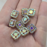 These Clear AB Rhinestone Slider Beads offer a beautiful combination of bright gold styling and color-shifting Aurora Borealis sparkle. Their compact square shape makes them versatile focal beads for bracelets, necklaces, earrings, pendants, and leather jewelry. The two-hole design provides stability within multi-strand jewelry, bead weaving, Peyote Stitch, and loom work projects, making them valuable additions to any collection of jewelry making supplies and jewelry components.