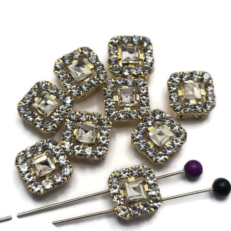 Add timeless sparkle to your jewelry designs with these Clear Rhinestone 2 Hole Slider Beads. Featuring brilliant clear rhinestones set in a bright gold finish, these focal beads are perfect for bracelet making, necklace designs, earrings, pendants, and multi-strand jewelry. Their dual-hole construction makes them ideal for bead weaving, Peyote Stitch, loom work, and artisan jewelry projects.