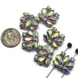 Add brilliant sparkle to your jewelry designs with these Clear AB Rhinestone Flower 2 Hole Slider Beads. Featuring shimmering Aurora Borealis rhinestones in a platinum silver finish, these floral focal beads display flashes of pink, blue, green, gold, and lavender. Perfect for bracelet making, necklace designs, earrings, pendants, and multi-strand jewelry, their dual-hole construction also makes them ideal for bead weaving, artisan jewelry, and custom handmade creations.