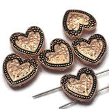 These beautiful Heart Slider Beads feature a raised heart centerpiece accented by decorative beaded borders and intricate metalwork in a bright copper finish with antique detailing. Their timeless design makes them ideal focal beads for bracelets, necklaces, pendants, and earrings. The two-hole construction keeps strands aligned, making these beads perfect for multi-strand jewelry, bead weaving, and meaningful handmade jewelry projects.