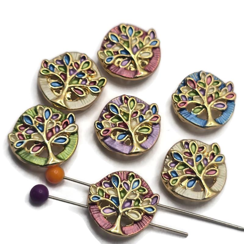 These Tree of Life 2 Hole Slider Beads feature a bright gold finish with colorful enamel detailing in shades of blue, green, lavender, pink, and ivory. The symbolic tree design makes these focal beads perfect for bracelet making, necklace designs, earrings, and pendants. Their dual-hole construction provides excellent alignment for multi-strand jewelry while adding meaningful beauty to handmade jewelry creations inspired by nature and family.