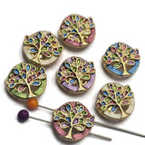 These Tree of Life 2 Hole Slider Beads feature a bright gold finish with colorful enamel detailing in shades of blue, green, lavender, pink, and ivory. The symbolic tree design makes these focal beads perfect for bracelet making, necklace designs, earrings, and pendants. Their dual-hole construction provides excellent alignment for multi-strand jewelry while adding meaningful beauty to handmade jewelry creations inspired by nature and family.