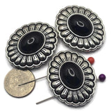 These Western Concho 2 Hole Slider Beads feature a smooth jet black lucite center framed by platinum silver with antique detailing. The classic scalloped concho design makes these focal beads perfect for bracelet making, necklace designs, earrings, and pendants. Their dual-hole construction provides excellent alignment for multi-strand jewelry while adding timeless Western style to handmade jewelry, leather accessories, and artisan jewelry creations.