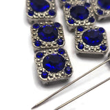 These Sapphire Blue focal beads combine antique silver styling with brilliant rhinestone accents to create eye-catching jewelry components. The square shape and dual-hole design make them ideal for bracelet making, necklace designs, leather jewelry, and artisan jewelry projects. Whether used individually or grouped together, these slider beads add sparkle, dimension, and professional detail to handmade jewelry, bead weaving, and custom accessory creations.
