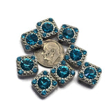 Add brilliant color and sparkle to your jewelry designs with these Aquamarine Rhinestone 2 Hole Slider Beads. Featuring a large faceted center rhinestone surrounded by coordinating aqua-blue accents in a platinum silver finish, these focal beads are perfect for bracelet making, necklace designs, earrings, pendants, and bead weaving projects. Their dual-hole construction makes them ideal for multi-strand jewelry, Peyote Stitch, loom work, and a variety of handmade jewelry creations.