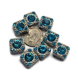 The refreshing aqua-blue color of these Aquamarine Rhinestone Slider Beads makes them a beautiful addition to bracelet making and necklace designs. Each bead features a sparkling faceted center rhinestone accented by smaller coordinating stones and finished in bright platinum silver. Their two-hole construction makes them perfect for bead weaving, artisan jewelry, pendants, earrings, and custom jewelry projects requiring decorative and functional focal beads.