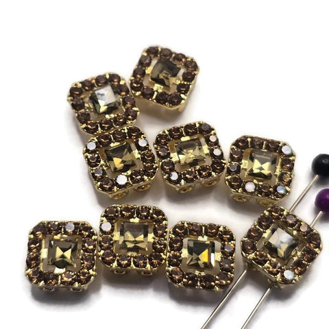 Add warm elegance to your jewelry designs with these Light Colorado Topaz Rhinestone 2 Hole Slider Beads. Featuring sparkling topaz-colored rhinestones set in a bright gold finish, these focal beads create beautiful accents in bracelets, necklaces, earrings, and pendants. The dual-hole construction makes them ideal for multi-strand jewelry, bead weaving, Peyote Stitch, and loom work projects. Their rich neutral color pairs effortlessly with countless jewelry making supplies and design styles.