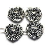 These antique silver Heart Concho Style 2 Hole Slider Beads bring Western charm and timeless symbolism to handmade jewelry designs. Featuring a raised heart center surrounded by detailed sunburst accents and decorative metalwork, they create beautiful focal points for bracelets, necklaces, and earrings. The dual-hole construction makes them ideal for multi-strand jewelry, bead weaving, leather jewelry, and artisan jewelry projects that celebrate love, friendship, and meaningful connections.
