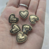 Create meaningful handmade jewelry with these heart-shaped 2 Hole Slider Beads in a bright gold finish with antique detailing. The raised textured heart design offers beautiful dimension while the decorative border enhances every piece. Ideal for bracelets, necklaces, earrings, leather jewelry, and bead weaving projects, these Slider Beads provide both beauty and stability for multi-strand jewelry and custom jewelry creations.