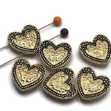Add a romantic touch to your jewelry designs with these bright gold Heart 2 Hole Slider Beads featuring antique detailing and a raised textured heart. Their dual-hole construction helps keep strands evenly aligned, making them ideal for bracelets, necklaces, bead weaving, Peyote Stitch, and Loom Work. These versatile focal beads complement both rustic Western jewelry and elegant vintage-inspired handmade creations.