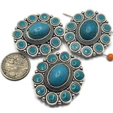 Create beautiful Western-inspired jewelry with these Silver Turquoise 2 Hole Slider Beads. Featuring a large faux turquoise center stone surrounded by smaller turquoise accents in an ornate silver concho setting, these focal beads are perfect for bracelets, necklaces, and multi-strand jewelry. Pair them with leather, natural stone beads, or silver findings to create rustic, Southwestern, rodeo, and boho jewelry with timeless Western charm.