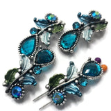 Create eye-catching jewelry with these Floral 2 Hole Slider Beads featuring brilliant blue teardrop crystals, shimmering rhinestones, and colorful enamel flowers and leaves. These decorative metal beads are ideal focal beads for bracelets, necklaces, bead weaving, and artisan jewelry. Their two-hole design keeps strands aligned while adding sparkle, color, and beautiful botanical detail to every handmade jewelry project.