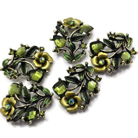 These Floral 2 Hole Slider Beads feature sparkling olivine crystals, detailed enamel flowers and leaves, and an antique silver finish that creates elegant botanical focal beads for handmade jewelry. Perfect for bracelets, necklaces, and multi-strand designs, these decorative metal beads pair beautifully with gemstones, pearls, seed beads, and leather to create nature-inspired jewelry with timeless style and professional results.
