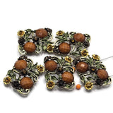 Bring woodland-inspired beauty to your handmade jewelry with these Floral 2 Hole Slider Beads. Their antique gold finish, decorative flowers, leafy vines, and faceted stones create eye-catching metal beads that make stunning focal beads for bracelets, necklaces, and artisan jewelry. Perfect for cottagecore, botanical, rustic, woodland, and vintage-inspired jewelry collections throughout every season.