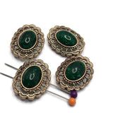 Create elegant handmade jewelry with these Emerald Green Oval 2 Hole Slider Beads featuring a rich emerald cabochon set in an ornate antique gold filigree frame. These beautiful focal beads are perfect for bracelets, necklaces, and multi-strand designs. Their two-hole construction keeps strands aligned while adding a timeless vintage look that pairs beautifully with pearls, crystals, gemstones, and other jewelry making supplies.