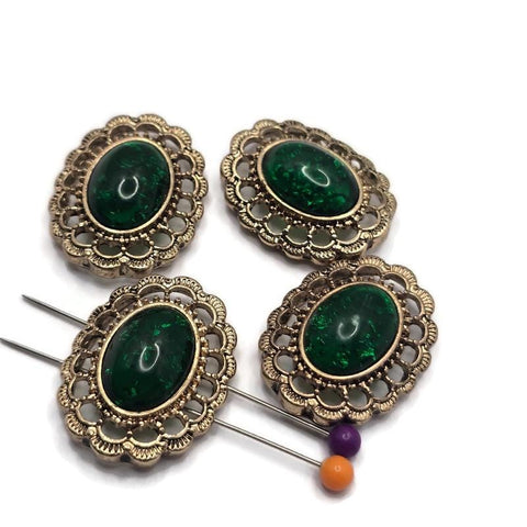 Create elegant handmade jewelry with these Emerald Green Oval 2 Hole Slider Beads featuring a rich emerald cabochon set in an ornate antique gold filigree frame. These beautiful focal beads are perfect for bracelets, necklaces, and multi-strand designs. Their two-hole construction keeps strands aligned while adding a timeless vintage look that pairs beautifully with pearls, crystals, gemstones, and other jewelry making supplies.