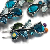 These antique silver Floral 2 Hole Slider Beads feature sparkling blue crystals surrounded by beautifully detailed enamel leaves for an elegant nature-inspired design. Ideal as focal beads for bracelets, necklaces, and bead weaving, these decorative metal beads coordinate beautifully with crystals, freshwater pearls, gemstones, and leather to create stunning handmade jewelry for every season.