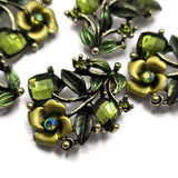 Create beautiful botanical jewelry with these Floral 2 Hole Slider Beads featuring faceted olivine crystals, hand-painted enamel details, and sparkling rhinestone accents. These decorative metal focal beads are ideal for bracelets, necklaces, bead weaving, and artisan jewelry. Their graceful floral vine design adds texture, color, and elegance to cottagecore, woodland, and vintage-inspired jewelry collections.