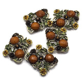 These Floral 2 Hole Slider Beads feature an antique gold finish with faceted brown stones, detailed flowers, and leafy vines for a timeless botanical design. These decorative metal focal beads are perfect for bracelets, necklaces, and multi-strand jewelry. Pair them with gemstones, pearls, leather, or seed beads to create elegant handmade jewelry inspired by nature, vintage gardens, and rustic woodland beauty.