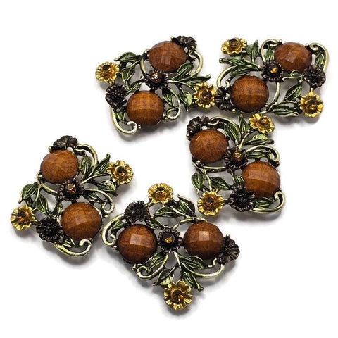 These Floral 2 Hole Slider Beads feature an antique gold finish with faceted brown stones, detailed flowers, and leafy vines for a timeless botanical design. These decorative metal focal beads are perfect for bracelets, necklaces, and multi-strand jewelry. Pair them with gemstones, pearls, leather, or seed beads to create elegant handmade jewelry inspired by nature, vintage gardens, and rustic woodland beauty.