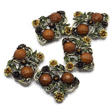 Create beautiful botanical jewelry with these Floral 2 Hole Slider Beads featuring faceted brown stones, detailed enamel flowers, and decorative leaves in an antique gold finish. These eye-catching metal focal beads are ideal for bracelets, necklaces, bead weaving, and artisan jewelry. Their graceful floral design adds warmth, texture, and vintage charm to every handmade jewelry project.