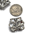 Add brilliant sparkle to handmade jewelry with these clear crystal 2 hole slider beads in a platinum silver or stainless steel-tone setting. Large faceted teardrop rhinestones create a dimensional flower-like pattern accented by smaller clear crystals. Measuring approximately 17 x 20 mm, these elegant focal beads are perfect for bracelets, necklaces, bead weaving, bridal jewelry, wedding accessories, and statement designs. Each package includes 5 clear rhinestone slider beads for jewelry making.