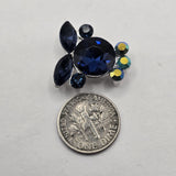 Deep blue rhinestone focal beads with Montana Blue crystals and sparkling Clear AB accents set in platinum silver tone metal. Round, marquise, and smaller faceted stones create a dimensional crystal cluster with flashes of navy, royal blue, teal, green, and gold. These 2 hole slider beads are ideal for double strand bracelets, bead weaving, necklaces, seed bead jewelry, multi-strand designs, and statement jewelry making projects.