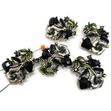 Rich antique gold, jet black rhinestones, and green and gray enamel come together in these beautiful floral 2 hole slider beads. The dimensional botanical design adds texture, sparkle, and vintage-inspired character to handmade jewelry. Use them as focal beads in bracelets, necklaces, multi-strand designs, bead weaving, or other jewelry making projects. Each measures approximately 30 mm long x 21 mm high with 12 mm between the loops. Five beads are included per package.
