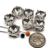 Give handmade jewelry brilliant sparkle with these Clear Rhinestone 2 Hole Slider Beads in a reflective bright silver finish. The large faceted crystal becomes the centerpiece of the design while the simple metal setting keeps the look clean and versatile. Perfect for bridal jewelry, DIY bracelets, necklaces, bead weaving, and double-strand designs. Each focal bead measures approximately 13 mm square with 7 mm between the holes. Package contains 6 slider beads.