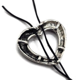 Textured antique silver open heart bead featuring a raised rope border and dark antiqued details. Two hidden stringing loops make this slider bead ideal for double strand bracelets, bead weaving, seed bead jewelry, Western designs, boho jewelry, and DIY jewelry projects.