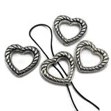 Silver rope heart 2 hole slider bead with antique detailing, open center, and hidden back stringing loops. Decorative focal bead for bracelet making, bead weaving, necklaces, seed bead designs, multi-strand jewelry, Western jewelry, and handmade accessories.
