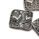 Silver heart 2 hole slider beads featuring detailed filigree scrollwork, open metal design, and two raised hearts. Perfect jewelry making supplies for double strand bracelets, bead weaving, necklaces, seed bead projects, romantic jewelry, and DIY handmade jewelry designs.