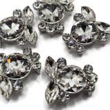 Platinum silver 2 hole slider beads covered with high-quality faceted clear rhinestones in round and marquise shapes. The dimensional crystal arrangement creates a sparkling floral-inspired focal bead for handmade bracelets, necklaces, bead weaving, and multi-strand jewelry. These decorative jewelry making beads pair beautifully with pearls, gemstones, seed beads, glass beads, and silver findings for bridal jewelry, formal accessories, and glamorous DIY jewelry designs.