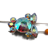 Sparkling Clear AB 2 hole slider beads in a platinum silver metal tone with high-quality faceted Aurora Borealis rhinestones. Round and marquise crystals create a dimensional floral-inspired design that changes color beautifully in different lighting. These crystal focal beads are perfect for bracelets, necklaces, bead weaving, seed bead projects, multi-strand jewelry, wedding accessories, and statement designs requiring brilliant rainbow sparkle.