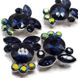 Montana Blue rhinestone slider beads featuring rich navy faceted crystals, marquise stones, and Aurora Borealis accents in a cool platinum silver finish. These multi-hole jewelry making beads have hidden loops on the back for double strand bracelets, bead weaving, seed bead designs, necklaces, and structured multi-strand jewelry. The combination of dark blue and Clear AB rhinestones creates dramatic sparkle for formal jewelry, evening accessories, and handmade statement pieces.