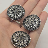 Black enamel western medallion 2 hole slider bead in an antique platinum silver finish. This oversized round focal bead features detailed floral and geometric patterns reminiscent of an ornate western concho. Ideal for statement bracelets, necklaces, western jewelry, bead weaving, and handmade jewelry projects.