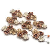 Elegant bright gold floral slider bead with sculpted copper, champagne-gold, and pearl-white flowers. The two-hole design makes this decorative focal ideal for bracelets, necklaces, bead weaving, and multi-strand handmade jewelry projects.