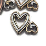 Unique soft gold and silver 2 hole slider bead featuring large and small open hearts in a mixed-metal design. Perfect for love-themed jewelry, friendship bracelets, handmade gifts, necklaces, bead weaving, and multi-strand bracelet designs.