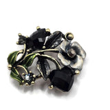 Add dramatic vintage-inspired detail to handmade jewelry with these antique gold floral 2 hole slider beads. Faceted jet black rhinestones create bold sparkle, while green and gray enamel leaves add beautiful contrast to the warm antique gold finish. These ornate focal beads are ideal for DIY bracelets, statement necklaces, bead weaving, and multi-strand jewelry projects. Each measures approximately 30 mm x 21 mm with 12 mm between the loops. Package includes 5 beads.