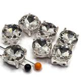 Add brilliant sparkle to handmade jewelry with these Clear Rhinestone 2 Hole Slider Beads. Each features a large faceted clear crystal set in a highly reflective bright silver metal finish. The classic design makes these beautiful focal beads for bracelets, necklaces, bridal jewelry, bead weaving, and multi-strand designs. The 13 mm square base has approximately 7 mm between the holes. Package includes 6 sparkling crystal slider beads.