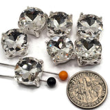 Create elegant crystal jewelry with these bright silver Clear Rhinestone 2 Hole Slider Beads. Large faceted clear stones reflect light beautifully, while the polished silver setting gives each focal bead a crisp, brilliant appearance. Use them for DIY bracelets, necklaces, multi-strand jewelry, bead weaving, bridal designs, or special-occasion jewelry. Each slider has a 13 mm square base with approximately 7 mm between the holes. Six rhinestone focal beads are included.