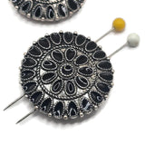 Large antique platinum silver 2 hole slider bead featuring an ornate circular medallion design with contrasting black enamel accents. Repeating teardrop details and textured metalwork give this focal bead a western-inspired concho appearance perfect for bracelets, necklaces, hat bands, and multi-strand jewelry making.