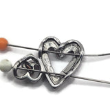 Soft gold and silver heart 2 hole slider bead with a unique large and small open-heart design. The mixed-metal finish makes this decorative focal easy to coordinate with gold, silver, crystals, pearls, seed beads, and other jewelry-making components.