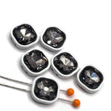 Decorative 2-hole slider beads with faceted black diamond rhinestones surrounded by bright white enamel metal frames. These square focal beads combine dark smoky sparkle with a clean white border for a dramatic modern jewelry design. Two stringing holes on each side make them ideal for double-strand bracelets, multi-strand beading, necklaces, and bead weaving. Unique jewelry-making supplies for DIY bracelets, handmade jewelry projects, beading designs, and jewelry makers.