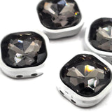 Black diamond crystal-style 2-hole slider beads for jewelry making featuring faceted smoky rhinestone centers and smooth white enamel metal settings. The square shape creates a modern focal point for handmade bracelets and necklaces, while two stringing holes on each side help keep the beads properly positioned. Eye-catching jewelry components for double-strand bracelet designs, simple bead stringing, bead weaving, handmade jewelry inspiration, and creative DIY jewelry-making projects at home.