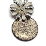 Bright silver and white enamel 2 hole slider beads featuring dimensional flower designs for bracelets and handmade jewelry. Each 17 mm floral focal bead combines neutral creamy white enamel with reflective silver petals. Two side stringing holes spaced approximately 5 mm apart make these decorative jewelry components useful for double-strand bracelets, necklaces, bead weaving, botanical jewelry, bridal designs, and jewelry making at home.